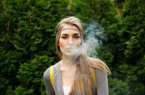 woman exhaling cannabis vape